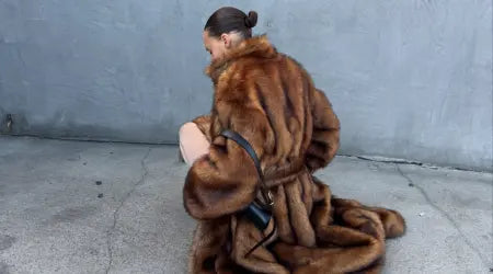 Loungewear for women featuring a woman in a luxurious brown faux fur coat with a sleek bun and a black handbag